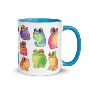 A colorful ceramic Frog Frenzy mug adorned with whimsical illustrations of vibrant, cartoonish frogs in various hues and poses, featuring the unique Chris Ryniak watercolor frog paintings from Bindlewood Shop.