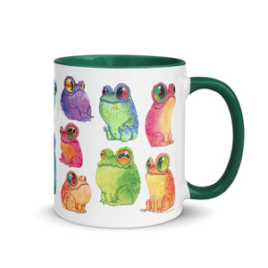 A white ceramic Frog Frenzy Mug adorned with colorful, whimsical illustrations of frogs in various hues and poses, featuring the unique Chris Ryniak watercolor frog paintings from Bindlewood Shop.