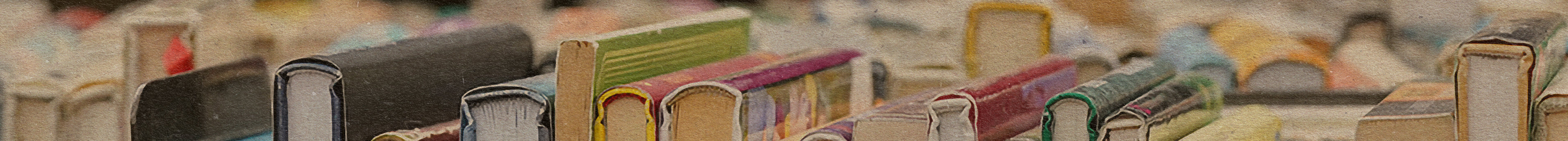 A row of books with various colored covers and visible page edges, lined up vertically on a bookshelf, viewed from above.