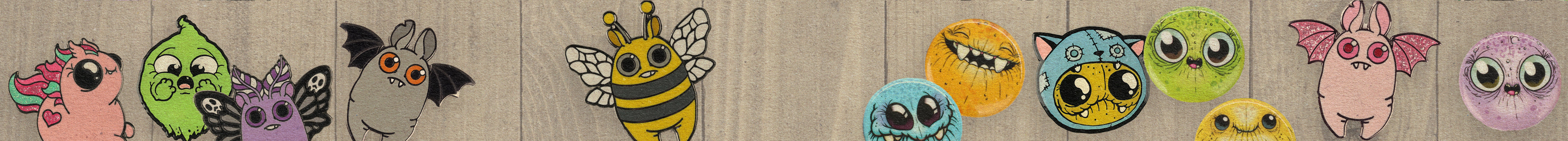 A row of colorful, cartoon monster stickers with big eyes and quirky features, arranged against a gradient orange and yellow background.