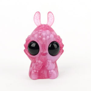 A cute opaque resin figure of Cactus Flower Foogbiffler, designed by Chris Ryniak, with large black eyes and little horns standing against a white background.
