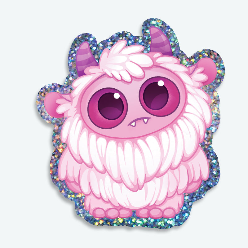 Introducing the Glitter Pink Yeti Sticker from Bindlewood Shop—a charming pink fluffy monster with big purple eyes, tiny fangs, and purple horns, accented by a sparkly glittery border. Perfect for fans of Amanda Louise Spayd or anyone who loves whimsical vinyl stickers!.