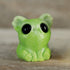 The Key Lime Smidgen by Chris Ryniak is a small, glossy green resin koala figure with oversized black eyes, large ears, and tiny paws, creating a cute and whimsical look.
