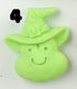 A light green, smiling cartoon witch face with a pointed hat and bold black number 4 on top left. Hand-sculpted Halloween Magnet by Bindlewood Shop—perfect for magnet collectors.