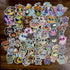 A vibrant ULTRA MEGA STICKER PACK! from Bindlewood Shop is displayed on a wooden surface, showcasing cartoon-style animal stickers with large, expressive eyes dressed in whimsical costumes like mummies, pumpkins, and bees. This playful collection is perfect for adding charm to your favorite items.