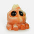 The Chris Ryniak Thai Tea Tank is a small, chonky, orange and cream-colored creature with big glossy black eyes, chubby cheeks, and tiny paws, posed cutely on a white background—just like a signature Ryniak resin figure.
