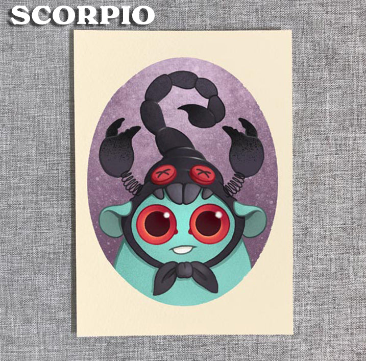From Bindlewood Shop's Zodiac Prints by Amanda Louise Spayd, this art features a cute cartoon creature in a scorpion costume with big red eyes, pincers, and a curled tail on a purple oval background with "SCORPIO" in bold white letters.
