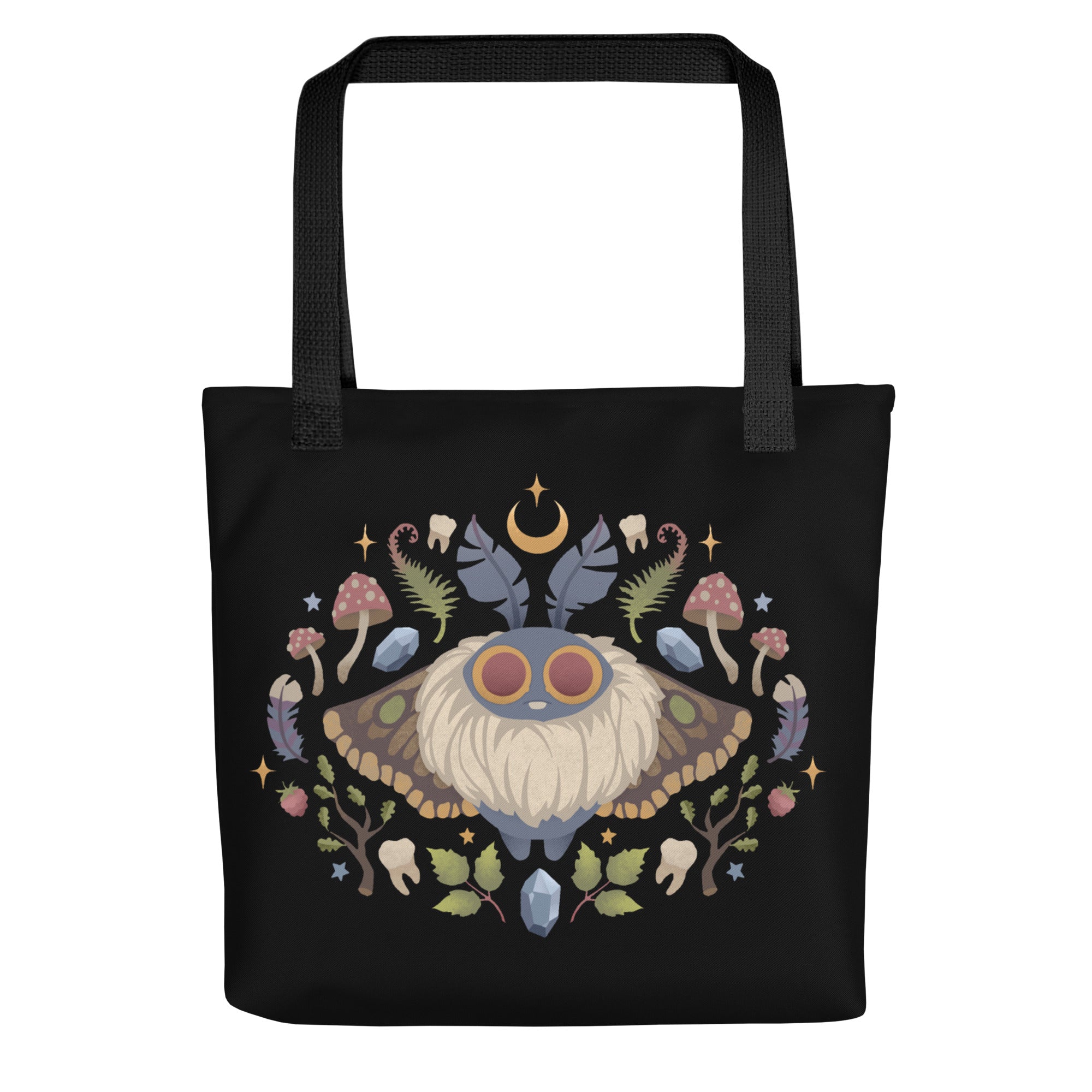 The Bindlewood Shop's Moth Magic Tote is a sturdy, weather-resistant bag featuring a vibrant symmetrical moth with large eyes, surrounded by mushrooms, leaves, crystals, acorns, and a crescent moon.