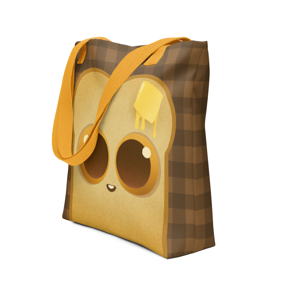 The Toast-Bag Tote from Bindlewood Shop is a brown checkered bag with yellow straps, featuring a cute cartoon bread slice with big eyes and butter—perfect for bakery runs or daily use.