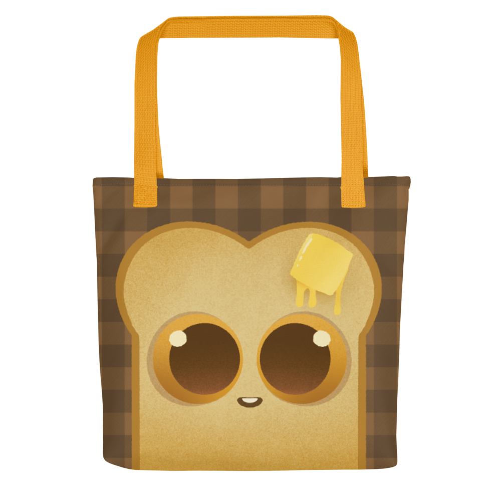 The Toast-Bag Tote from Bindlewood Shop is a durable bag with orange handles, featuring a cute cartoon toast with big eyes, a melting butter pat, and a smiling mouth on a dark brown plaid background.