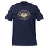 The Moth Magic Tee from Bindlewood Shop is a navy blue shirt with a colorful moth graphic, red eyes, botanical details, mushrooms, and a crescent moon above its head.