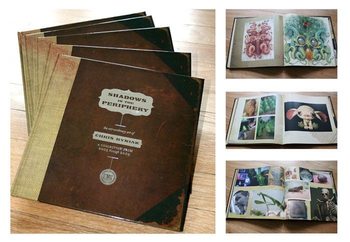 The brown hardcover books, titled "Shadows In The Periphery" from Bindlewood Shop, feature a small emblem. Open pages display vibrant art illustrations and rest elegantly on wood, reflecting Chris Ryniak's unique style.