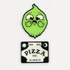 The OMGhost Pin Set by Bindlewood Shop features a cute green cartoon character pin with big eyes and a black and white “YES YES PIZZA YES ALWAYS” spirit board-style pin with moon and sun corners, shown on a plain light background.