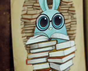 A bespectacled blue cartoon rabbit peeking over a stack of illustrated books, surrounded by a circular pattern of brown pages from Thimblestump Hollow in the "So Many Books" Print by Amanda L Spayd.