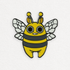 A whimsical, cartoon-style enamel Lemon Bee Pin of a cute "Lemon Bee" character designed by Amanda Louise Spayd, with large eyes and a friendly expression from Bindlewood Shop.