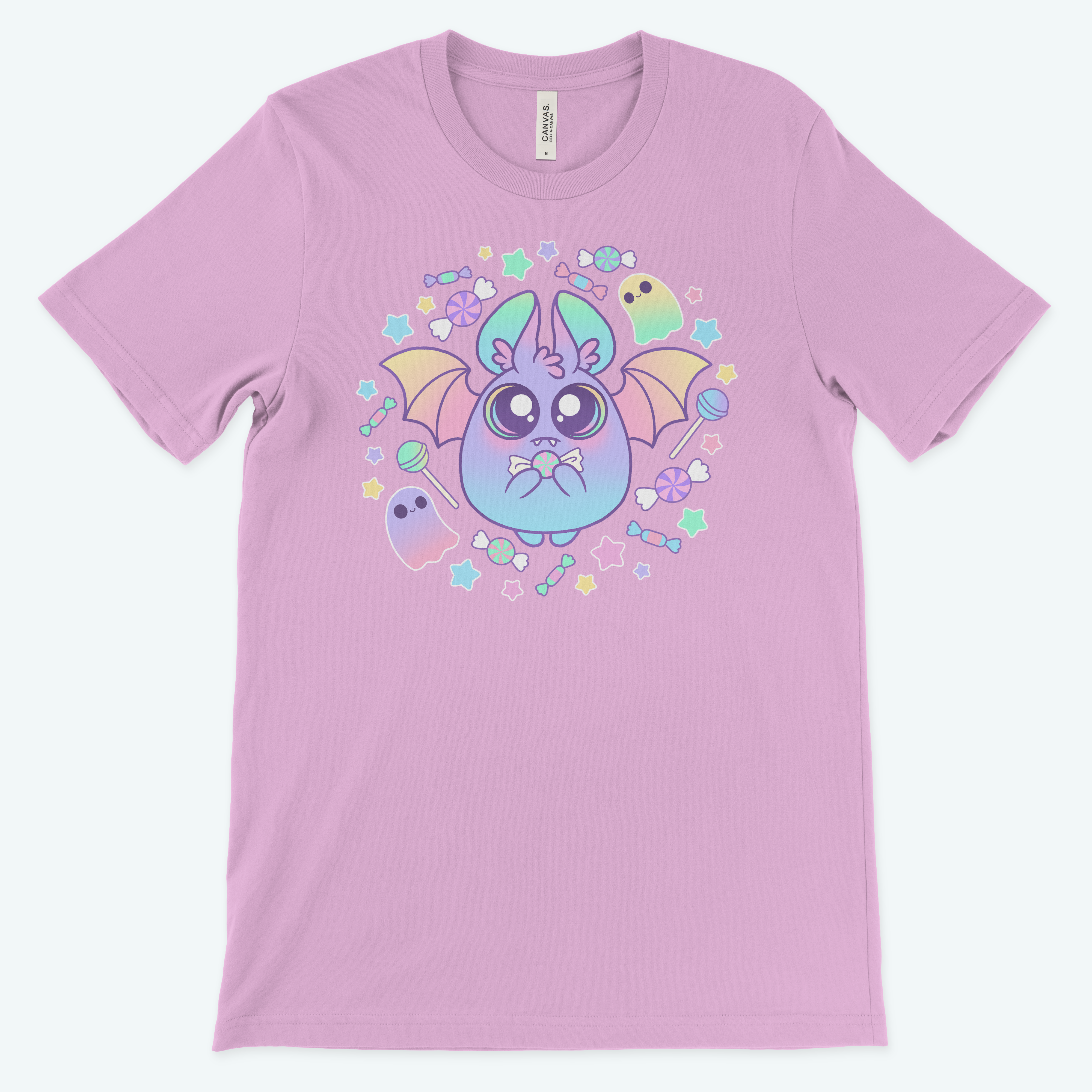 The Pastel Candy Bat Tee by Bindlewood Shop features cute pastel bats, stars, candies, and ghosts. This kawaii lavender t-shirt offers a gender-neutral fit—perfect for anyone who loves adorable fashion!.
