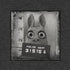 The Bindlewood Shop’s Pipsqueak Mugshot Tee features a black-and-white cartoon rabbit with wide eyes and mugshot sign 315154, standing before a height chart—perfect for fans of vintage-style shirts.