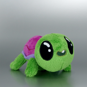 A Tordish magnetic plush toy of a green cartoon caterpillar with large, cute eyes and a purple segment on a grey background, from Bindlewood Shop.