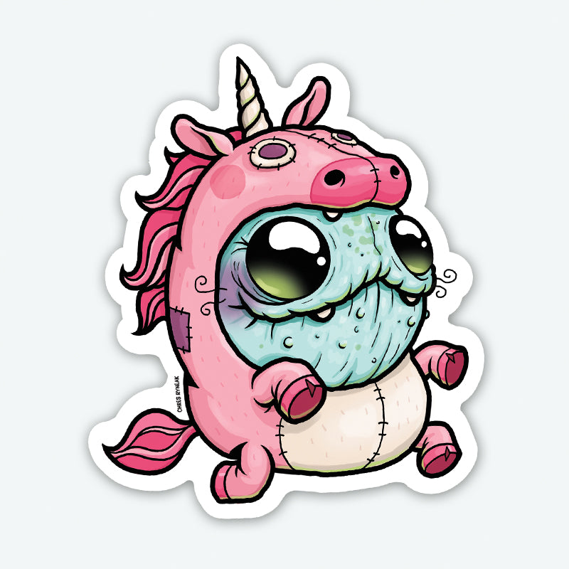 The Unicorn Suit Sticker from Bindlewood Shop features a stuffed, blue-skinned cartoon character with large eyes and a droopy mouth, dressed in a whimsical pink unicorn onesie complete with a horn, ears, mane, and tail. This sticker captures an adorable yet odd appearance that would make for high-quality stick-on decorations.