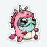 The Unicorn Suit Sticker from Bindlewood Shop features a stuffed, blue-skinned cartoon character with large eyes and a droopy mouth, dressed in a whimsical pink unicorn onesie complete with a horn, ears, mane, and tail. This sticker captures an adorable yet odd appearance that would make for high-quality stick-on decorations.