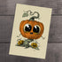 The "Vintage Vine" print by Chris Ryniak features a whimsical illustration of a large, cute pumpkin with big eyes and a smiling face perched on a twisting vine, accompanied by two smaller smiling pumpkins at the base against a wooden background. The cartoonish style is ideal for an archival paper fine art print.