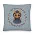 The Twilight Sprite Throw Pillow by Bindlewood Shop showcases an Amanda Louise Spayd illustration of a charming, round-eyed character in a bonnet and lacy dress. The character is encircled by a beautiful arrangement of flowers and leaves on a light grayish-blue background, making it ideal for cottagecore interior design.