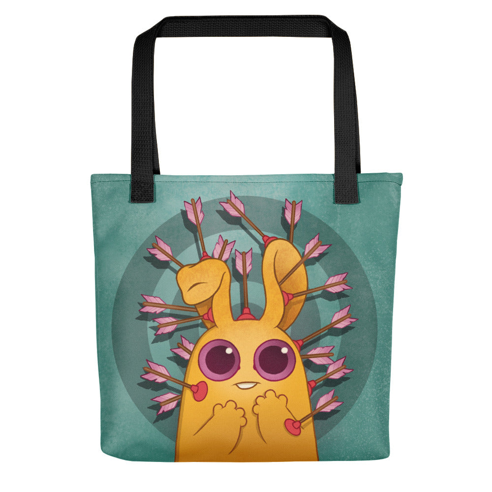 The Bindlewood Shop Sagittarius Tote is a durable printed bag featuring a charming yellow bunny with big purple eyes, heart-shaped hands, and long ears, surrounded by pink-tipped arrows on a green circular background.