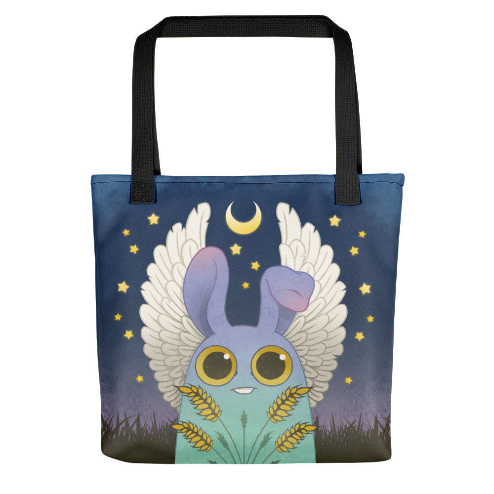 The Virgo Tote from Bindlewood Shop features a cute blue creature with bunny ears and white wings holding wheat beneath a crescent moon—perfect as an astrology gift or stylish everyday bag.