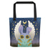 The Virgo Tote from Bindlewood Shop features a cute blue creature with bunny ears and white wings holding wheat beneath a crescent moon—perfect as an astrology gift or stylish everyday bag.