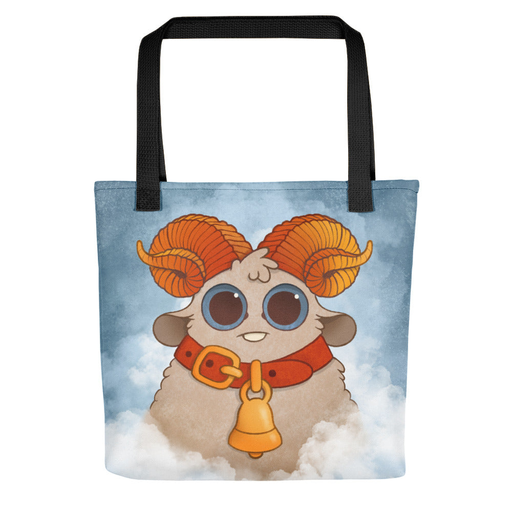 The Bindlewood Shop's Aries Tote features an adorable cartoon sheep with large, curly orange horns and wide eyes, wearing a red collar with a gold bell. The sheep stands on a cloud in front of a blue sky, perfect for wool craft enthusiasts or as your spacious, sturdy everyday bag.