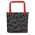 A dark gray tote bag made of durable fabric features a pattern of black cartoon owls with red eyes and beaks. The Mothman Cryptid Tote by Bindlewood Shop, ideal for cryptid-hunting paraphanalia or as a quirky Mothman tote bag, has bright red handles that create a striking contrast with the dark background and design.