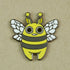 A whimsical Bindlewood Shop Lemon Bee pin depicting a cheerful, cartoon-style bee with big eyes and two antennae on a plain background, designed by Amanda Louise Spayd.