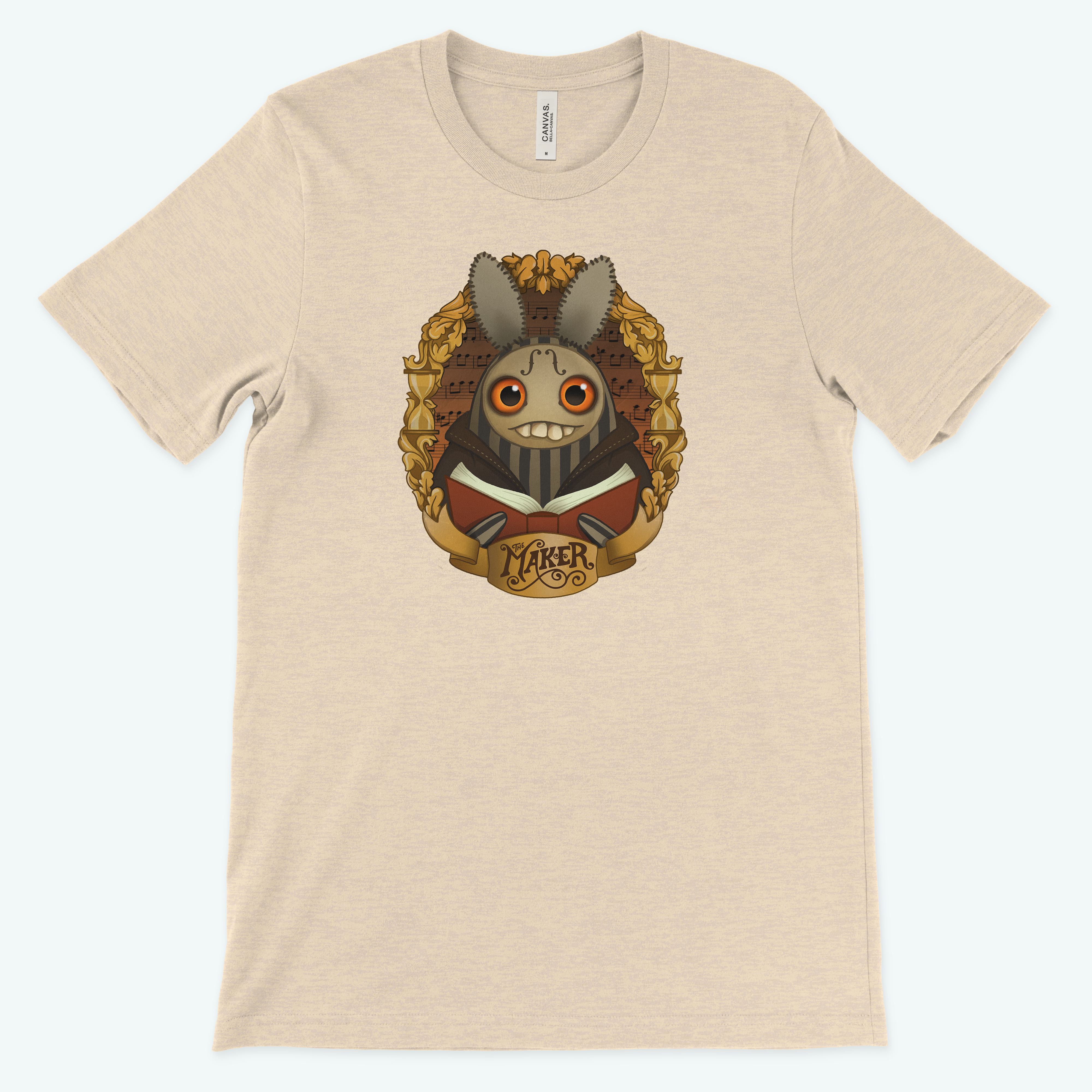 The Maker" Tee by Bindlewood Shop features original art from Amanda Louise Spayd with a smiling, stylized steampunk rabbit showcasing gears and mechanical elements. "Maker" beneath the design. This light beige, gender-neutral shirt captures unique artistry.