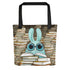 The So Many Books Tote by Bindlewood Shop features a blue cartoon bunny with large glasses reading among stacks of books—an ideal library tote or thoughtful gift for any book lover.