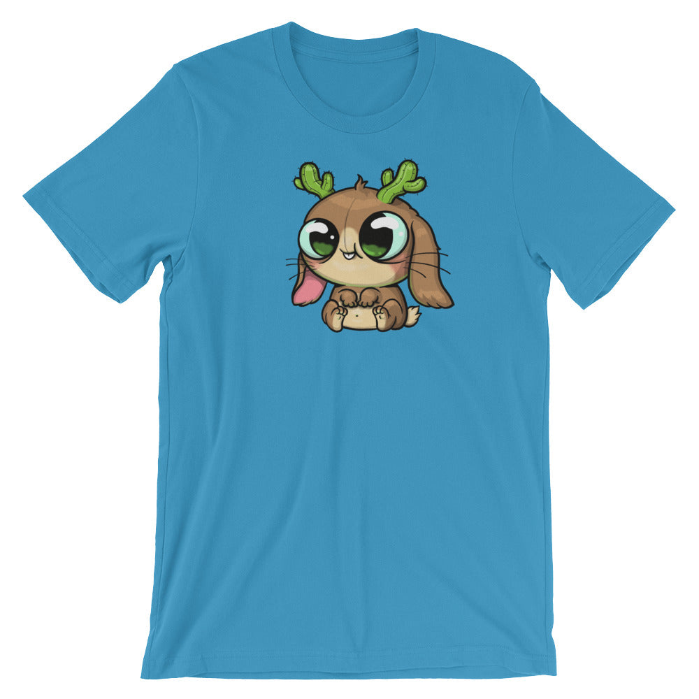 The Cactalope Tee from Bindlewood Shop displays a Chris Ryniak-inspired cartoon animal with big eyes, brown fur, green antlers, and a playful protruding tongue on a blue T-shirt. It offers a gender-neutral fit for enhanced comfort and style.