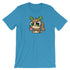 The Cactalope Tee from Bindlewood Shop displays a Chris Ryniak-inspired cartoon animal with big eyes, brown fur, green antlers, and a playful protruding tongue on a blue T-shirt. It offers a gender-neutral fit for enhanced comfort and style.