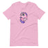 A cozy shirt featuring a whimsical design of Chris Ryniak's Flooficorn with big green eyes, a purple mane, and tail. This pink t-shirt showcases sparkling stars around the chubby unicorn with a small smirk on its face, offering a cute, fantasy-themed illustration in a gender-neutral fit. The Floofy Unicorn Magic Tee from Bindlewood Shop is sure to enchant anyone who wears it.