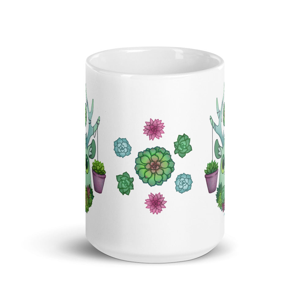 The Succulent Mug from Bindlewood Shop is a white ceramic piece adorned with vibrant illustrations of green and purple succulents in pots featuring intricate geometric patterns. Dishwasher safe, this lively and artistic mug mesmerizes with its symmetrical arrangement.